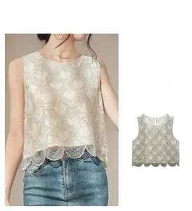 Detail of beaded sequin vest with scalloped fish scale patterns and wavy hem