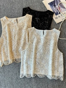 Flat lay of elegant sleeveless sequin tops with wave patterns and scalloped hems in three colors
