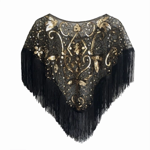 Detail view of 1920s vintage shawl featuring golden sequin embroidery and black tassels