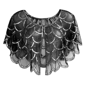 Detailed macro view of 1920s vintage black mesh shawl with scalloped silver sequins