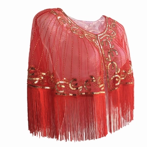 Close-up of red mesh shawl featuring golden sequin patterns and long fringe tassels