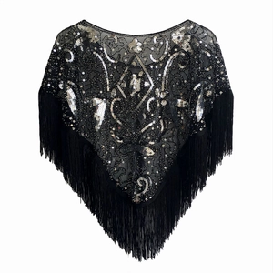 Detail of 1920s vintage black mesh shawl featuring silver sequins and fringe trim