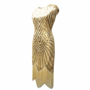 Detail of 1920s vintage gold sequin dress with art deco patterns and fringe hem