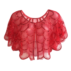 Detail view of red sequin shawl with elegant scalloped edges and scale pattern embroidery