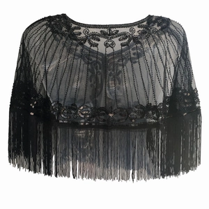 Detail of vintage 1920s black mesh cape with intricate sequin embroidery and long tassels