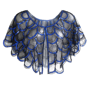 Detail of 1920s vintage sequin shrug with blue and black mermaid scale pattern lace