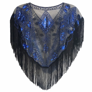 Detail of vintage 1920s shawl with blue sequins and long tassels on black mesh fabric