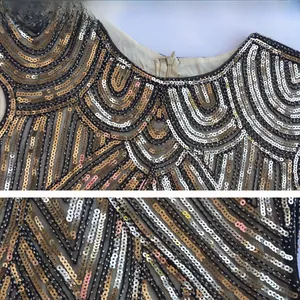 Detail view of 1920s vintage sequins embroidery with hidden zipper and mesh fabric
