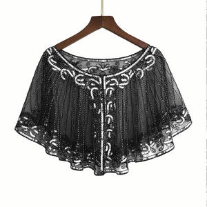 Detail of 1920s vintage black mesh cape with intricate silver sequin embroidery