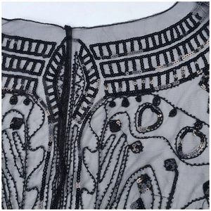 Vintage 1920s style black mesh shawl with intricate sequin embroidery and beadwork