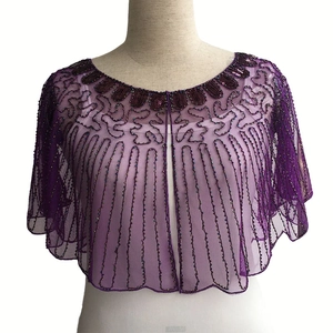 Detail of purple sequin beaded capelet showing intricate wave patterns on sheer mesh