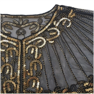 Close-up of vintage black mesh shawl with Art Deco gold sequins and fringe details
