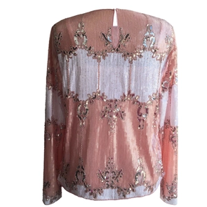 Detailed back view of women's sequined top with pink and white stripes and keyhole neck