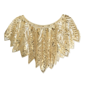 Detail of golden sequined shawl featuring intricate radiating leaf patterns on mesh