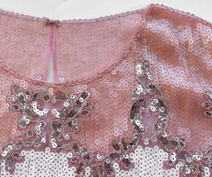 Detailed view of pink sequin top with beaded neckline and hook-and-eye closure