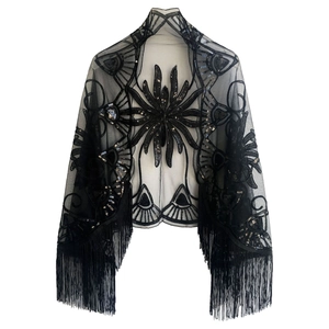 Detail of black mesh shawl featuring vintage 1920s sequin embroidery and tassel fringe