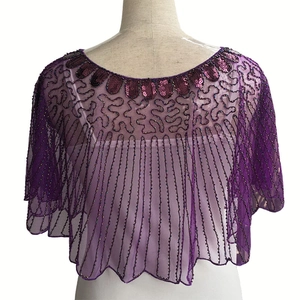 Close-up of purple mesh sequin capelet with detailed beadwork and vintage wave patterns