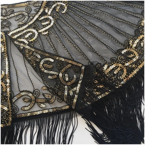 Detailed view of Art Deco gold sequins and beads with long fringe on black mesh shawl