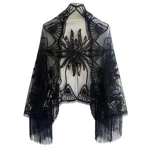 Detail of black sequin floral embroidery and tassels on semi-transparent mesh shawl