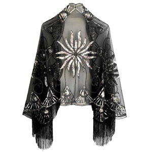 Detail of black mesh evening shawl with silver sequins, floral embroidery and long tassels