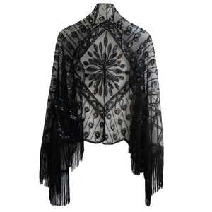 Detail of 1920s vintage black mesh shawl with sequins, beadwork and fringe hem