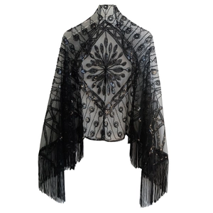 Detailed macro view of 1920s vintage black shawl with sequins embroidery and long fringe trim