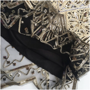 Detail of 1920s Gatsby style dress with gold and silver sequin embroidery on mesh