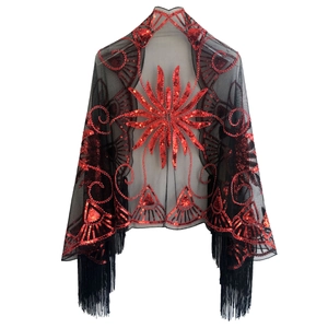 Detail of red floral sequin embroidery and long black tassels on mesh party shawl