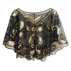 Detailed macro of vintage black mesh shawl with gold sequins in paisley pattern