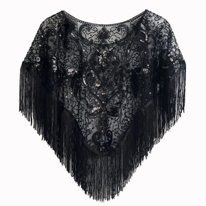 Detail of 1920s vintage black lace shawl with sparkling sequins and long fringe trim