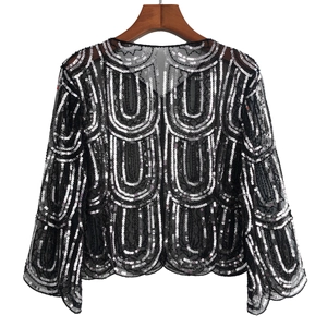 Detail of 1920s vintage black mesh shawl with silver sequins in an inverted U-pattern