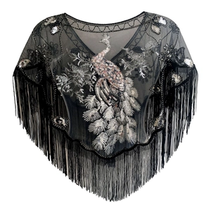 Detail of silver peacock sequin embroidery and black fringe tassels on mesh evening shawl