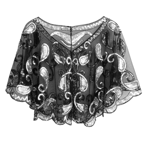 Detail of black mesh shawl with silver sequin paisley patterns and wavy edges
