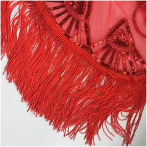 Macro view of red sequins and long fringe details on evening gown wrap shawl