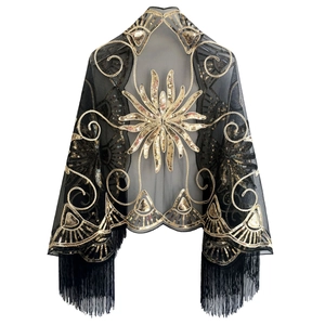 Detailed close-up of Art Deco gold sequins and black fringe tassels on sheer mesh shawl