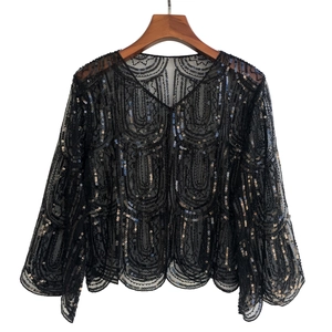 Close-up of mesh evening shawl featuring wavy sequins and bell sleeves detail