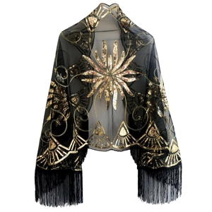 Detail of black mesh evening shawl with gold sequins and elegant long fringe trim