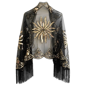 Detailed view of black mesh shawl with gold sequins and long fringe for evening wear