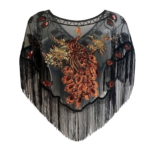 Detail of black mesh shawl with gold sequin peacock embroidery and long fringe trim