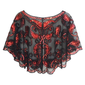 Close-up of black mesh shawl with intricate red sequin paisley patterns and scalloped edges