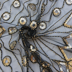 Detailed close-up of 1920s vintage black mesh with gold sequins and beaded embroidery
