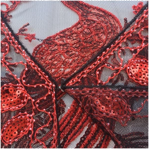 Close-up of red sequin peacock embroidery and beads on black mesh evening shawl
