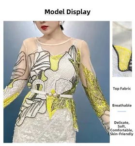 Detailed macro view of floral sequin embroidery on breathable mesh white lace top