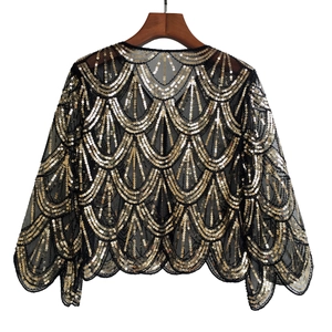 Detail of vintage 1920s sequin shrug with gold and silver fan pattern on black mesh