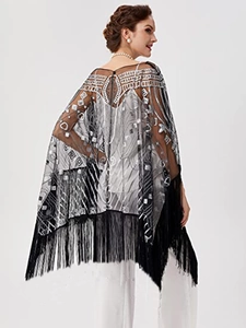 Detail of 1920s vintage black mesh shawl featuring silver sequins and long fringe trim