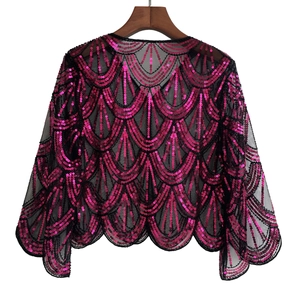 Detail of rose red sequins in a fish scale pattern on black mesh evening shawl bolero