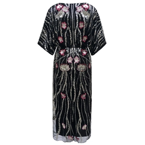 Back view of a 1920s vintage black sequined dress with floral embroidery and sequins
