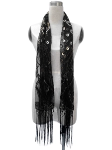 Detail of black mesh shawl with sequins, beadwork embroidery and long fringe trim