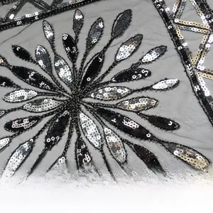Detail of black mesh fabric with radiant silver sequins and floral embroidery texture