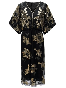 Close-up of gold sequin floral embroidery on a black V-neck 1920s vintage party dress